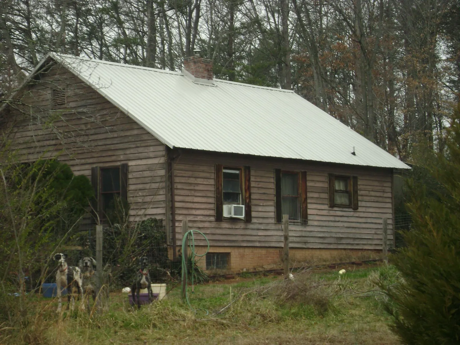 White metal roof on an old wood sided farmhouse, from a Metal Roof Installation job in Valentines